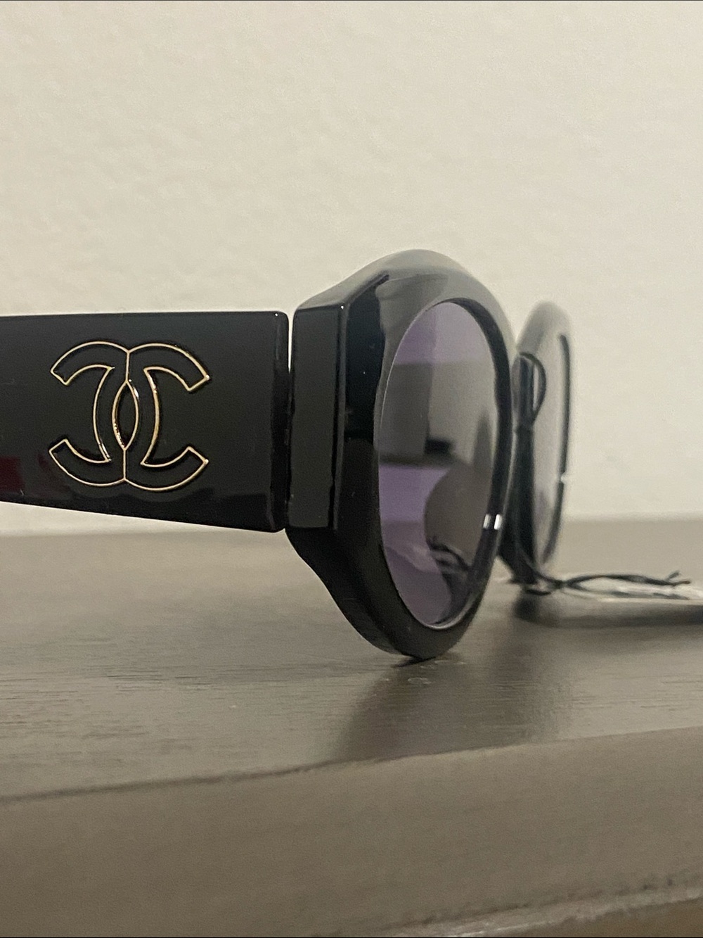 Black Sunglasses with Gold Logo and Purple Lenses